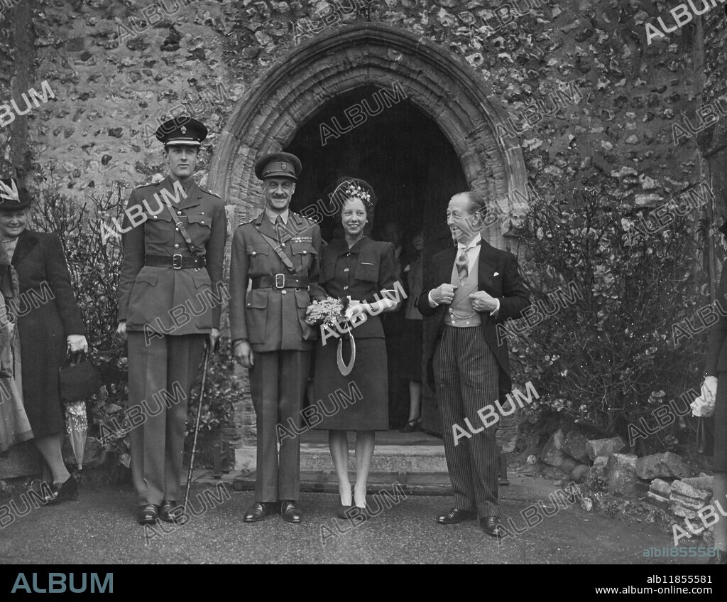 Brig Ralph Algar Bagnold, O.B.E., F.R.S., the well-known explorer and Miss Dorothy Plank were married at St Margaret's Rottingdean, Sussex. The brigadier was awarded the founders medal for the Royal Geographical Society in 1935 for exploration in the Libyan desert and is a world-famous authority on sand particles. Sir Roderick Jones gave Miss Plank away. Miss Plank has been secretary companion and close friend to Lady Jones, sister of brigadier's Bagnold for 15 years. The wedding was followed by a reception at Kipling's old house, the Elms. Picture shows left-to-right Lt. Timothy Jones, the bridegroom and the Bride and Sir Roderick Jones after their wedding ceremony. 8 May 19 46.