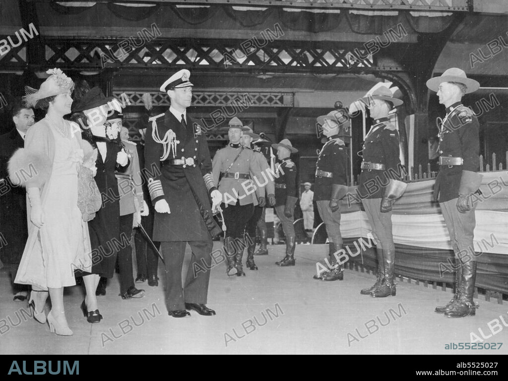 King and Queen Leave Quebec for Montreal - The King and Queen pass through a guard of honour provided by the Royal Canadian Mounted Police -The famous "Mounties" - as they make their way to the Royal Train in Quebec Station friar to leaving for Montreal. May 23, 1939.