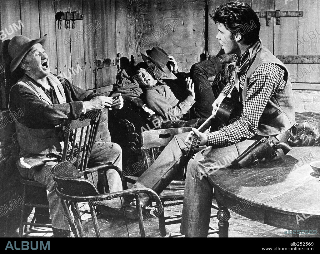 DEAN MARTIN, RICK NELSON (RICKY) and WALTER BRENNAN in RIO BRAVO, 1959, directed by HOWARD HAWKS. Copyright WARNER BROTHERS.
