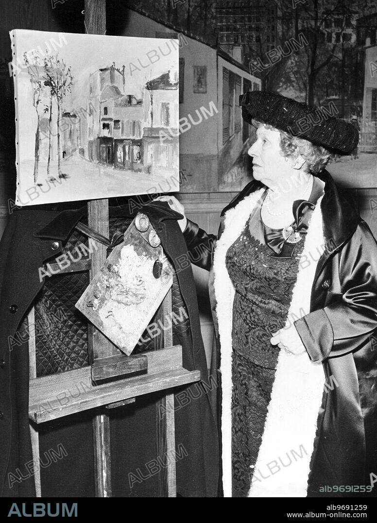 Lucie Valore - French painter standing by one of her paintings. 15 February 1957. [caption in French].