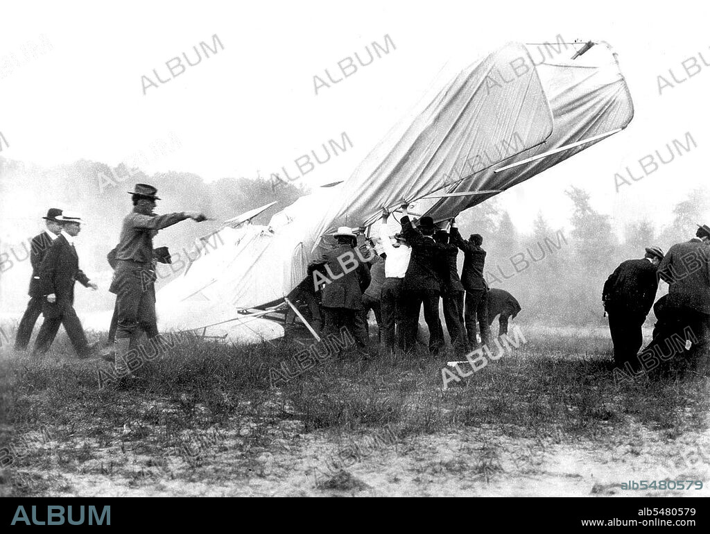 1908 - Bystanders help extricate the mortally wounded US Army (USA) Lieutenant (LT) Thomas Selfridge from the wreck of the Wright Brothers Flyer after its crash at Fort Myer, Virginia (VA). At right, several men attend the injuries of Orville Wright, who lies on the ground at their feet.