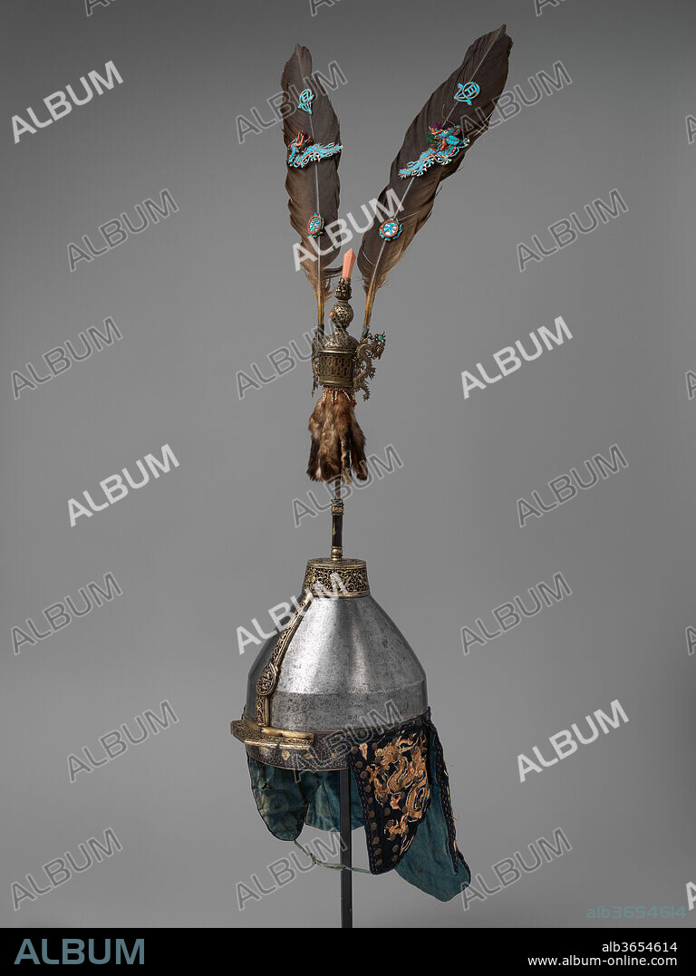 Helmet with Feather Crest. Culture: Chinese. Dimensions: Helmet (36.25.7a); H. including nape defense 20 3/4 in. (52.7 cm); H. excluding nape defense 11 1/4 in. (28.6 cm); W. 9 in. (22.9 cm); D. 10 1/4 in. (26 cm); Wt. 4 lb. 9 oz. (2069.5 g). Date: 17th-18th century.
The quality of the pierced and gilt ironwork of the helmet, the four-claw dragons embroidered on its cheek and neck guards, and the exotic materials of the crest indicate that these items were intended for a military officer of very high rank.