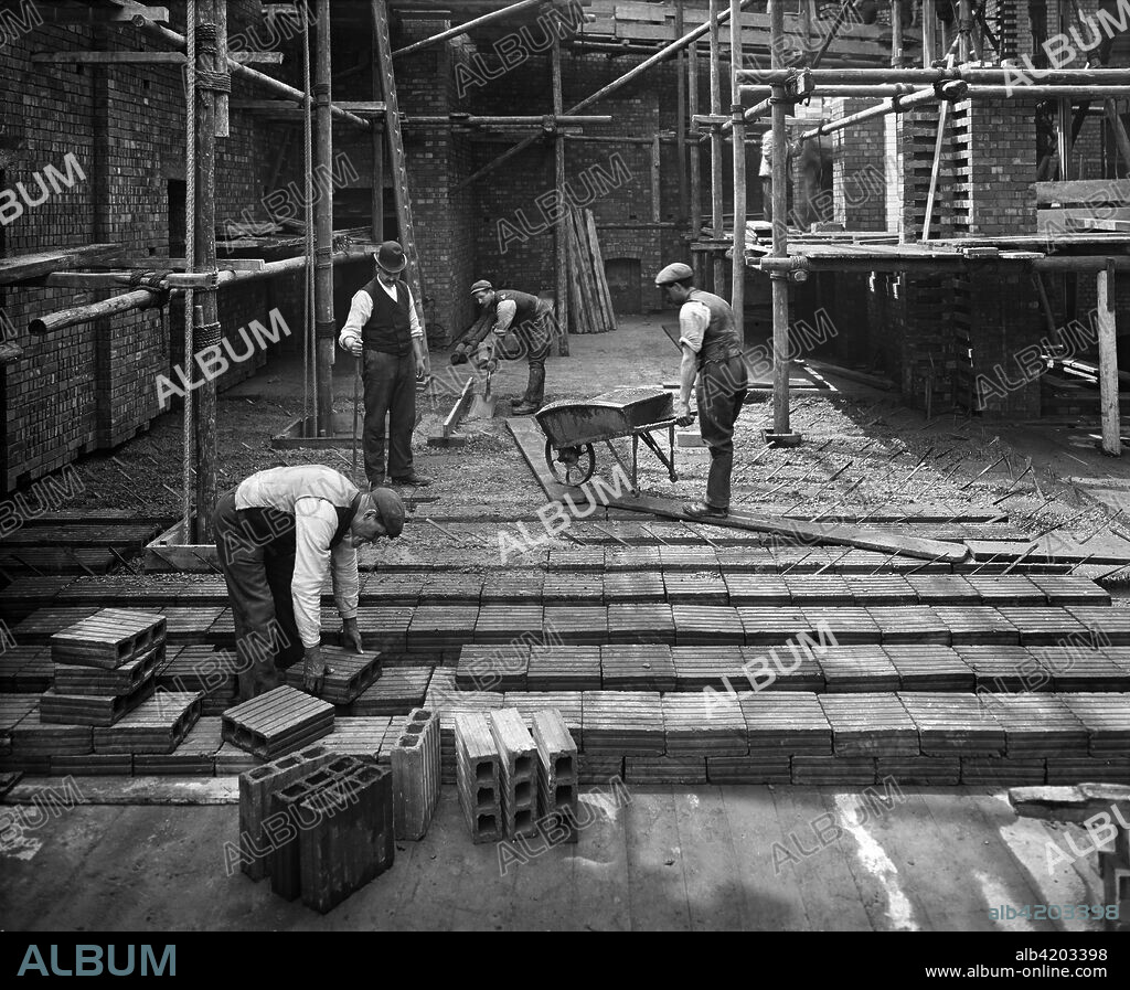 Construction workers laying a hollow pot floor, 8 Lloyds Avenue, City of London, 1907. The 'hollow pot' system, known as the Kahn system, was invented by Julius Kahn in 1903 and was much used for flooring. This building was designed by Richard Norman Shaw for Associated Portland Cement Manufacturers.