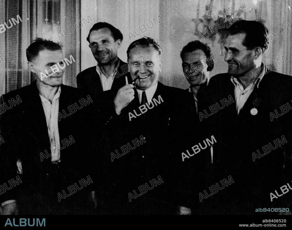 Tito Is Not Worried -- Marshal Josip Broz Tito (centre) premier of Yugoslavia, smiles jovially and shows little concern for the Russian "Gold war" as he meets a group of crack goal.Miners at White Castle, his residence in Belgrade September 11. At right is Alija Sirotanovich, who has broken all records for individual output in the Yugoslav goalfields. September 15, 1949. (Photo by Associated Press Photo).