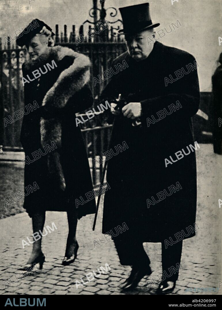 'At the Duke of Connaught's Funeral', January 1942, (1945). British Prime Minister Winston Churchill and his wife Clementine (1880-1977) at the funeral of Prince Arthur, Duke of Connaught and Strathearn. The Duke was the third son of Queen Victoria, and died at the age of 91. Churchill (1874-1965) was Prime Minister of the United Kingdom from 1940 to 1945, and again from 1951 to 1955. From "The Life and Times of Winston Churchill", by Malcolm Thomson. [Odhams Press Limited, London].