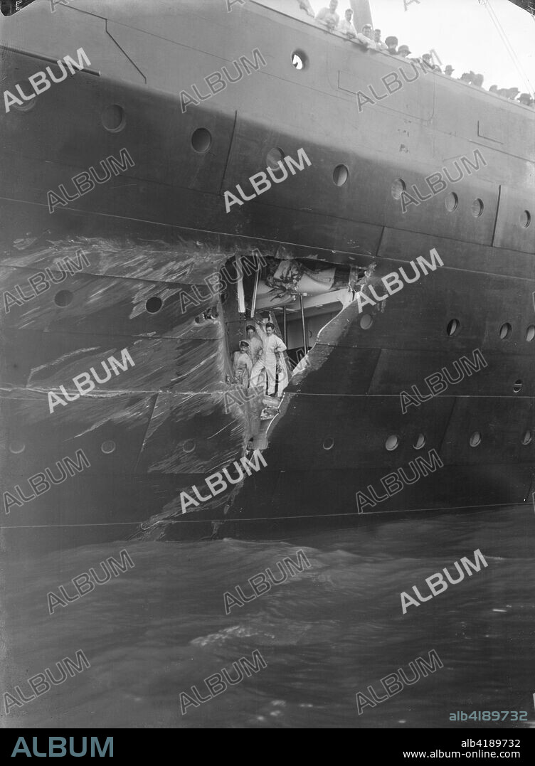 Hole torn in the hull of 'RMS Olympic' after the collision with 'HMS Hawke' in the Solent, 20th September 1911. The collision took place as Olympic and Hawke were running parallel to each other through the Solent. As Olympic turned to starboard, the wide radius of her turn took the commander of Hawke by surprise, and he was unable to take sufficient avoiding action. Hawke's bow, collided with Olympic's starboard side near the stern, tearing two large holes in Olympic's hull, above and below the waterline which resulted in the flooding of two of her watertight compartments and a twisted propeller shaft. At a subsequent inquiry the Royal Navy blamed Olympic for the incident, alleging that her large displacement generated a suction that pulled Hawke into her side.