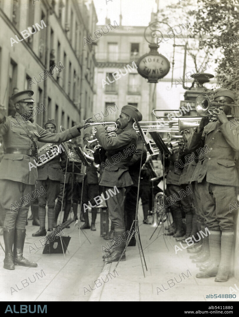 Genuine jazz for the yankee wounded in the courtyard of a Paris hospital for the American wounded, led by Lt. Europe. James Reese Europe (1881 - 1919) was an African-American ragtime and jazz arranger, composer and bandleader. During WWI he saw combat as a lieutenant with the 369th Infantry and led their regimental band. US Army/Signal Corps, 1918 (cropped and cleaned).