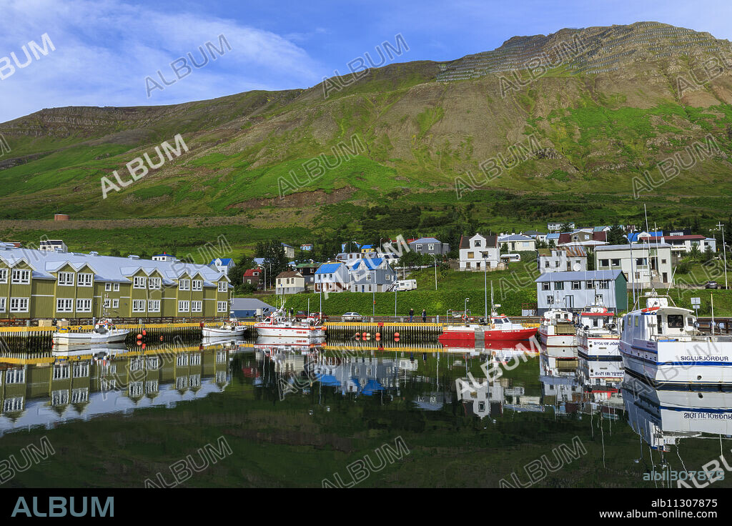 Harbour, hotel and fishing boats, mountains, reflections, Siglufjordur, (Siglufjorour), stunning Summer weather, North Iceland, Europe.