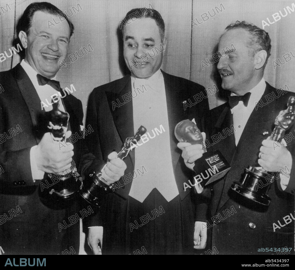 Win Double Oscars -- Joseph L. Mankiewicz (left) and Darryl Zanuck pose with Dr. Ralph Bunche (center) of the United Nations after they each won two awards at last night's Oscar Presentations. Mankiewicz' work on "All About Eve" won his honors: best direction and best screenplay. Zanuck produced the same picture, which was named the Oscar's best and also won the Irving Thalberg Memorial award for outstanding movie achievement. April 19, 1951.