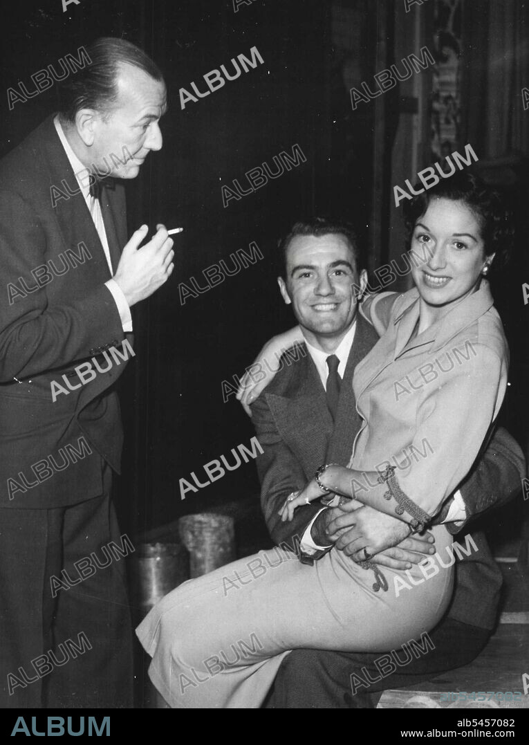 Noel Coward Looks On - As The Stars Rehearse.Noel Coward smokes an on-stage cigarette as he watched the two stars Graham Payn and Pat Kirkwood rehearse his new musical show "Ace of Clubs". April 18, 1950. (Photo by Keystone).