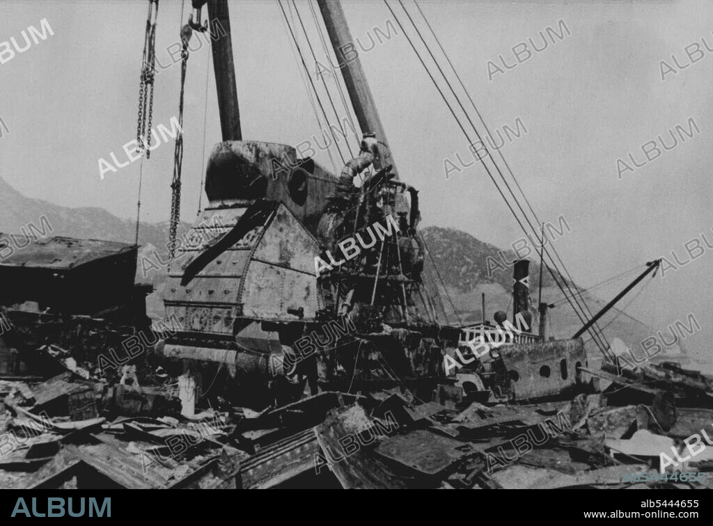 The Pride Of Japan - Now Being Cut Up For Scrap -- The scene on the deck of the "Haruna". Acetylene burners are used to literally out the ship to pieces. One of the the pride of the Imperial Japanese Navy, 39,000 ton battleship "Haruna" has recently been refloated at Etajima near the headquarters of the British Occupation Forces in Japan - and is now being dismantled to provide scrap metal for Japanese industries. The "Haruna" was sunk towards the end of the last war. April 27, 1951. (Photo by Sports & General Press Agency Limited).
