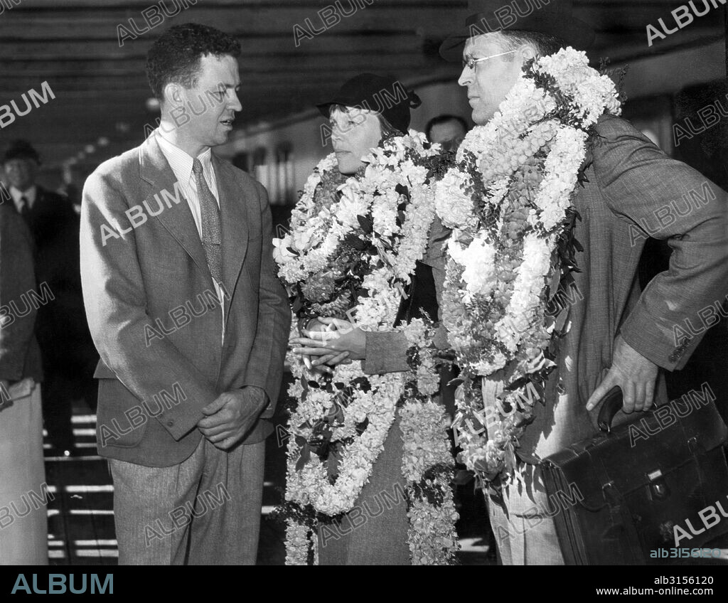 Honolulu, Hawaii:  December 27, 1934. Amelia Earhart and her husband, George Putnam, are greeted by Lt. Johnson of the Naval Fleet Air Base.