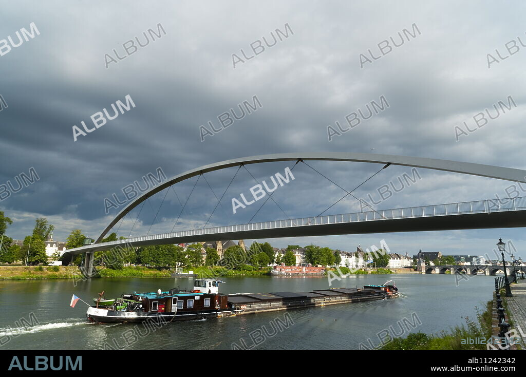 Barge under the Hoger Brug (Higher Bridge) on the River Maas, Maastricht, Limburg, The Netherlands, Europe.