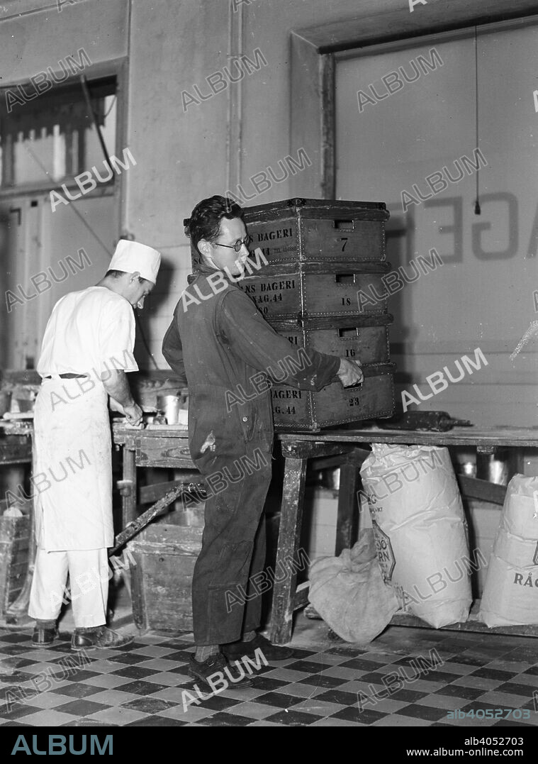 Delivery boy picking up bread  boxes at the Lisa Öhman Bakery, Stockholm, Sweden, 10th October 1942.