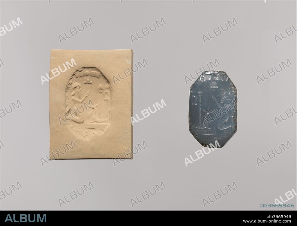 Stamp seal: worshiper kneeling before mushhushshu-dragon and standard. Dimensions: Seal Face: 2.41 x 1.55 cm
Height: 3.12 cm
String Hole: 0.2 cm. Date: ca. 6th-5th century B.C..
This stamp seal depicts a kneeling figure before divine symbols. The figure, bearded and wearing a diadem, raises his hands in a gesture of prayer and supplication. Before him can be seen a couchant mushhushshu, the composite dragon associated particularly with Babylon's chief deity Marduk, whose spade "standard" rises from its back. It is possible that the mushhushshu and spade standard represent a real altar before which the figure kneels, but other elements of the composition are abstract divine symbols: behind the standard sits a symbol resembling the Greek letter "omega," and above the scene is a winged disc. 
Many Neo-Babylonian seal designs show a standing or kneeling worshipper with raised hands before divine symbols or an altar. In some cases the figure is beardless and clearly a priest; in others, as here, the figure may represent a priest or king. Although often very finely carved, the seals are notable for the simplicity of their compositions and, unusually for ancient Near Eastern seals, their inclusion of large areas of blank, uncarved space.