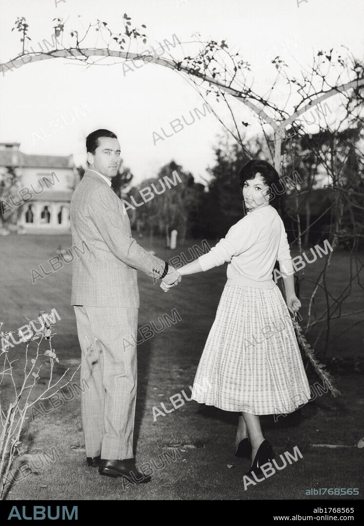 Gina Lollobrigida with her husband Milko Skofic. Italian actress Gina Lollobrigida walking hand in hand with her husband, Slovenian doctor, Milko Skofic in the garden of their residence on the Appian way. Rome, January 1958.