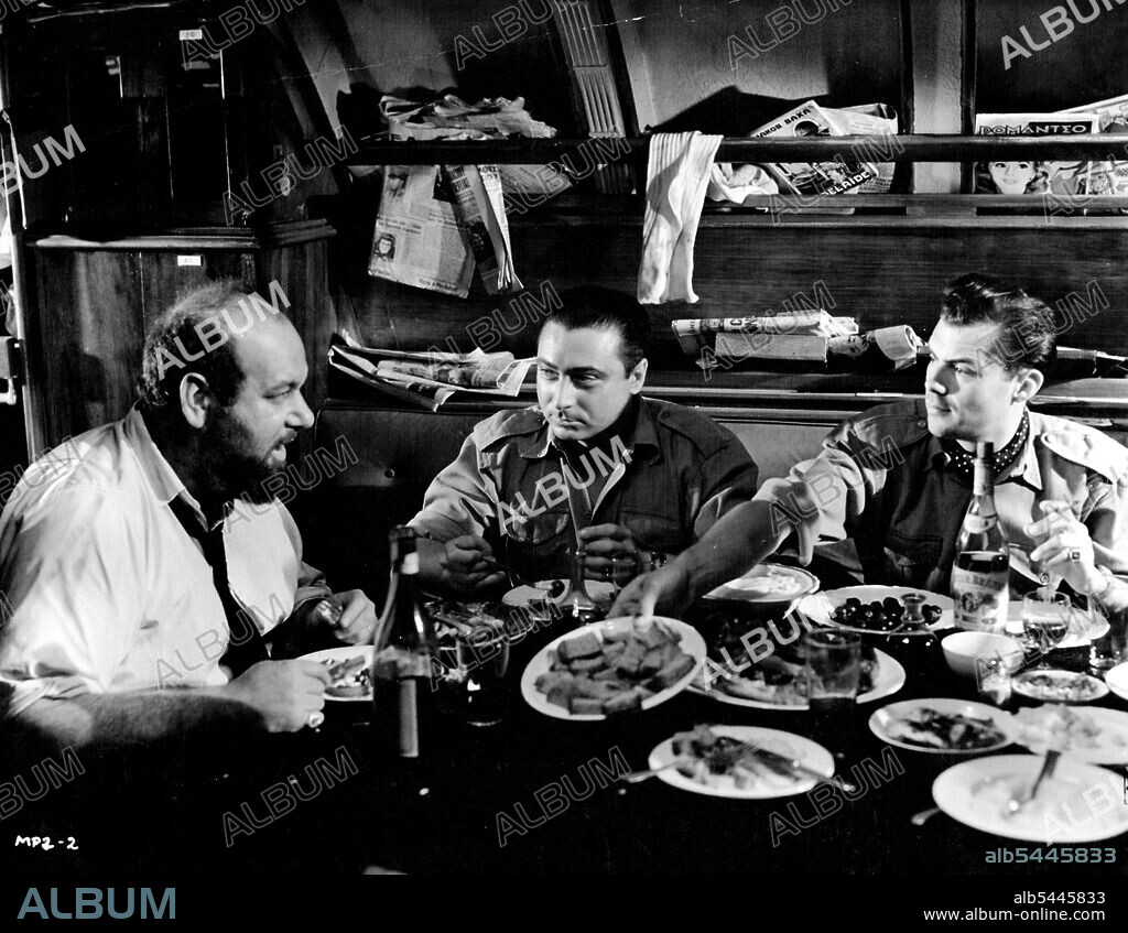 On board the Greek submarine taking them to Rhodes, Captain Papadopoulos (Eric Pohlmann) discusses details of the landing arrangements with George Two, (Gerard Oury) and the British leader of the expedition, Lieut. Graham, (Dirk Bogarde). Is a Mayflower Picture Prodution, starring Dirk Bogarde. Denholm Eillott and Akim Tamiroff. Produced by Aubrey Baring and Maxwell Setton and directed by Lewis Milestone. Screenplay by Robert Westerby. In Colour by Technicolor. Distributed by British Lion Film Corporation. Made at Shepperton Studios. January 10, 1955.