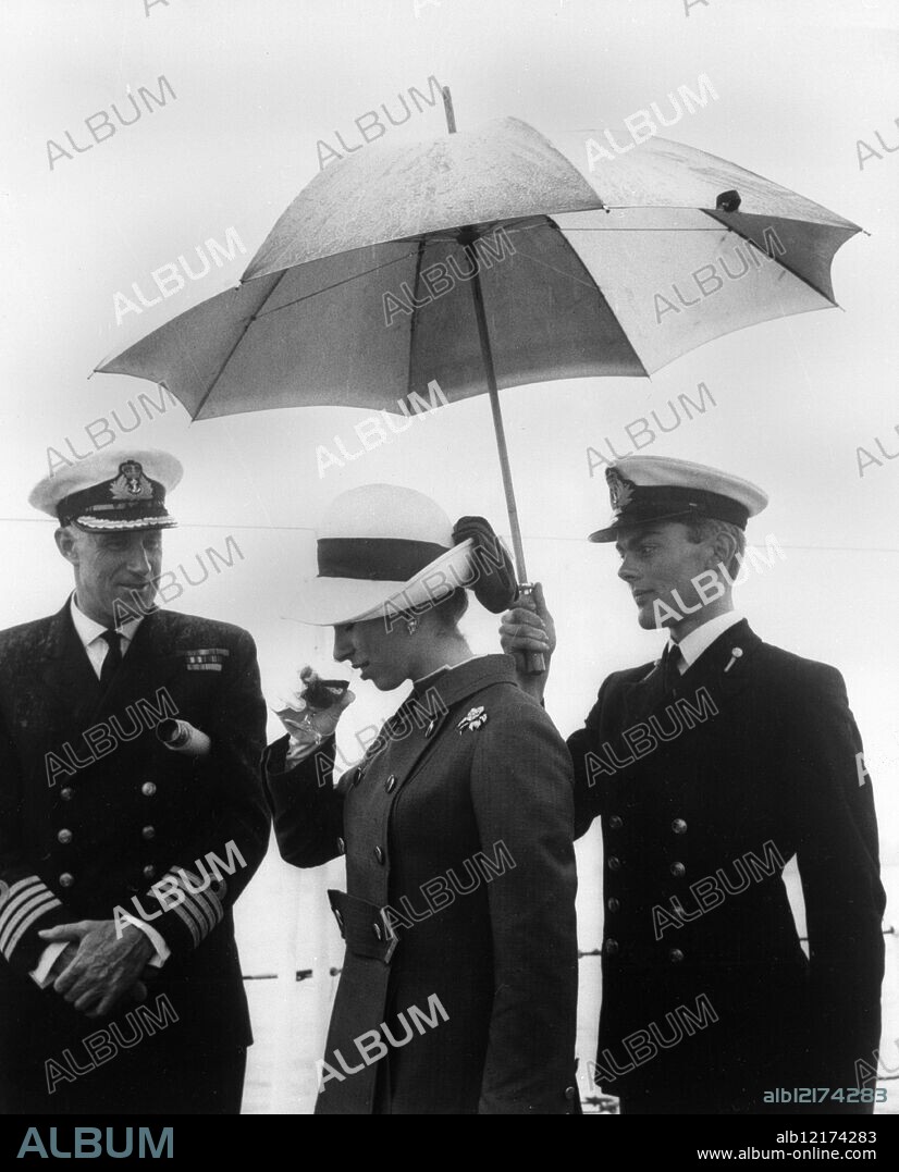 HRH Princess Anne considers a glass of 'grog' - Naval rum - before tasting the Royal Navy's traditional drink during her visit to HMS Eastbourne off Torbay, Devon, England, today, as the 'grog' was being issued. - The Princess, with HM The Queen, Prince Philip and the Prince of Wales, is on a two day visit to ships of the Western Fleet now anchored off Torbay. - 28 July 1969.