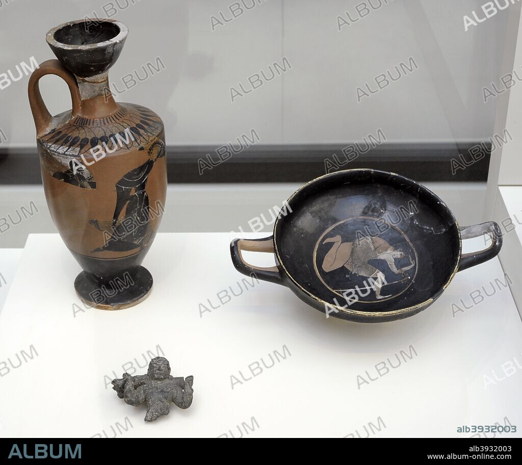 Iberian culture. Grave goods. Attic lekythos of black figures depicting two satyrs running after a woman, perhaps a nymph; Attic cup (kylix) of red figures, attributed to the painter of Pithos, depicting a naked young man jumping or dancing before a staff and a bronze handle with a young man holding the tail of a lion. 500-490 BC. Manufactured in Greece. Found in the Necropolis of Pozo Moro. Chinchilla de Monte-Aragon (province of Albacete, Castile-La Mancha, Spain). National Archaeological Museum. Madrid. Spain.