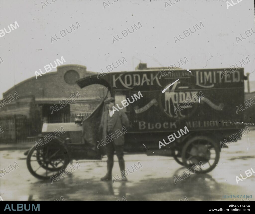 Lantern Slide - Kodak Delivery Truck, Melbourne, 1910 - 1920, Black and white lantern slide, featuring a photograph of a man standing in front of a Kodak Australasia Limited delivery truck, advertising the company's retail store in the Block Arcade, Melbourne. This image would have been taken circa 1910 - 1920 but it is unknown whether the lantern slide was made at this time. collection of products, promotional materials,.