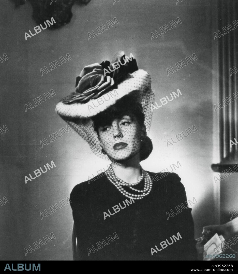 Woman wearing a hat and veil by the French fashion designer Jacques Fath, France, 1943.