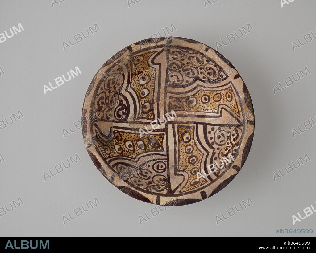 Imitation Bichrome Luster Bowl. Dimensions: H. 2 7/16 in. (6.2 cm)
Diam. 8 1/8 in. (20.6 cm). Date: 9th century.
The decoration of this bowl imitates a type of luster ceramic usually dated to the mid- to late ninth century, characterized by the use of two shades of a brownish-gold glaze. Instead of being made with the metal-based glaze of luster ware, though, this bowl is decorated with brown and yellow glazes made of diluted clay. Its interior is divided into quarters by projecting vertical strokes; each quadrant is decorated with the "peacock-eye" pattern so common on luster wares of this period.