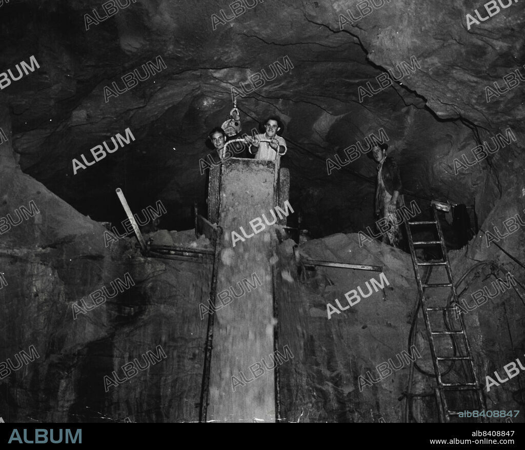 Men blast away the rock to extend the face of a channel from a sedimentation tank towards the pumping wells and machinery room. The rock is shevelled on to a chute and falls into a truck below. August 4, 1950.