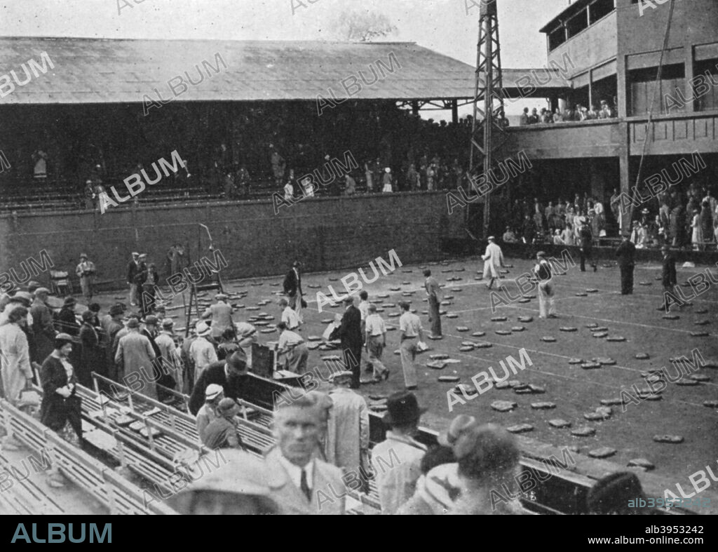 The cushion bombardment of No 1 Court due to play being cancelled as a result of rain, Davis Cup, Wimbledon, 1935. A print from Wimbledon Story, by Norah Gordon Cleather, Sporting Handbooks Ltd, London, 1947.