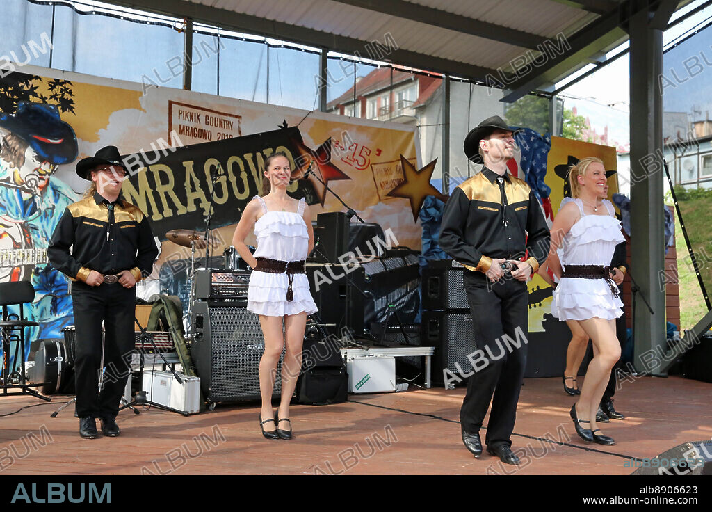 July 25, 2015 - Mragowo. Poland. 26-07-2015 Photos by Jerzy Dabrowski.The Piknik Country Mragowo is the Polish capital of country music. The Picnic takes place since 1983 and is an event of international importance, to which thousands of music fans arrive every year. Free special events are organized in addition to the amphitheater stage festival concerts on the shores of Czos Lake, such as music bands performances: cowboy costume shows, exhibitions, competitions, great cuisine, swimming marathon and the Country Parade. Nearly two-hour parade is an attraction for motorist guests. It involves the motorcycles, and strange, colorful cars! Mragowo turns into the Wild West town during the Country Picnic. A contest for the best country store exhibition in which shops and service outlets participate contributes to it. Motorcycle and vintage cars rallies are organized during the festival. Unusual and beautiful vintage motorcycles and cars dominate the downtown are adding color to the city and are an additional attraction. Fun few days of the party changes usually quiet streets of the town. Music, dance, sound of engines are ubiquitous and create a unique atmosphere! This year a special guest from the States was Rosannie Cash. (Credit Image: © Jerzydabrowski@Ons.Pl/ZUMA Wire).