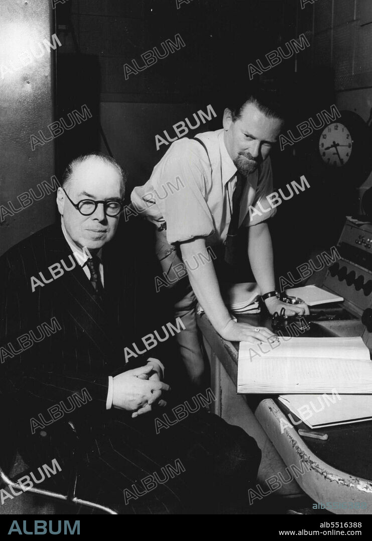 Wyndham Lewis Listens To "The Childermass" -- Wyndham Lewis author and painter, listens to a rehearsal of "The Childermass", his book which was recently adapted for radio and broadcast in the British Broadcasting Corporation's Third Programme. Behind him is D.G. Bridson, BBC feature producer, script writer and poet, who collaborated with Wyndham Lewis in the adaptation. Following on the successful broadcast of Part I of "The Childermass" - a book which was primarily conceived as a trilogy - the BBC has now commissioned Mr. Wyndham Lewis to complete Part II. October 10, 1951. (Photo by British Broadcasting Corporation).
