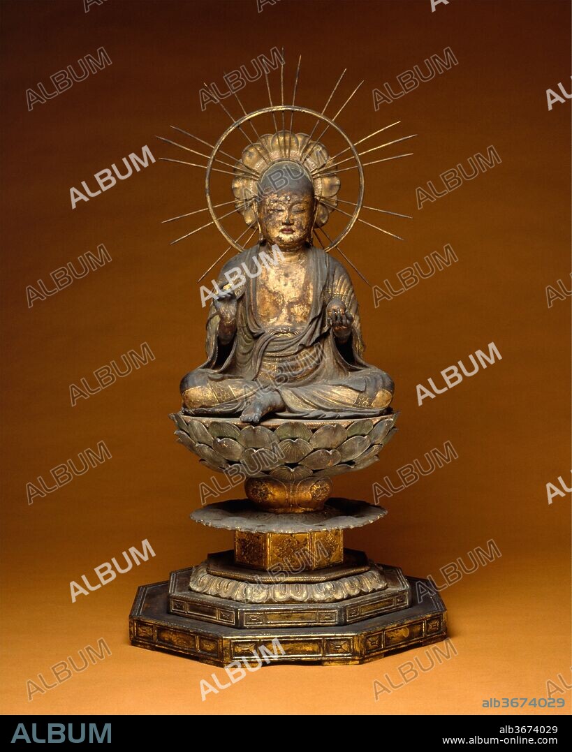 Jizo Bosatsu (Ksitigarbha). Culture: Japan. Dimensions: H. 45 3/4 in. (116.2 cm); W. 24 1/8 in. (61.3 cm); D. 23 7/8 in. (60.6 cm). Date: second half of the 13th century.
Represented in the guise of a Buddhist monk and devoid of the crown and jewels customarily worn by bodhisattvas, Jizo Bosatsu is among the most readily recognizable of the many deities in the Buddhist pantheon and perhaps the most sympathetic. Called Ksitigarbha ("Earth Womb") in Sanskrit, his worship originated in Central Asia. It reached Japan in the eighth century but flourished during the Kamakura period in connection with the Pure Land sects. Although Jizo is invoked for many roles--as protector of travelers, of children, and of women in childbirth--he was especially venerated for his intervention on behalf of those suffering in hell, the lowest of the Six Realms of Existence. He is portrayed as a monk with an open, compassionate expression ready to hear the call of the suffering. In his hand is a traveler's staff, its six rings a symbol of the extent of his mercy through all realms of being, and its clinking sound a signal of his foot's fall lest he harm even the smallest creature. 
This serenely graceful figure exemplifies the idealistic sculptural style that was often employed to convey the special ethos of Pure Land Buddhism: Jizo's warm, truthful facial features give him a compassionate expression that invites faith, which, in turn, will lead to salvation. His gently flowing robe, with its finely crafted gold-leaf designs, enhances the impression of elegant refinement.