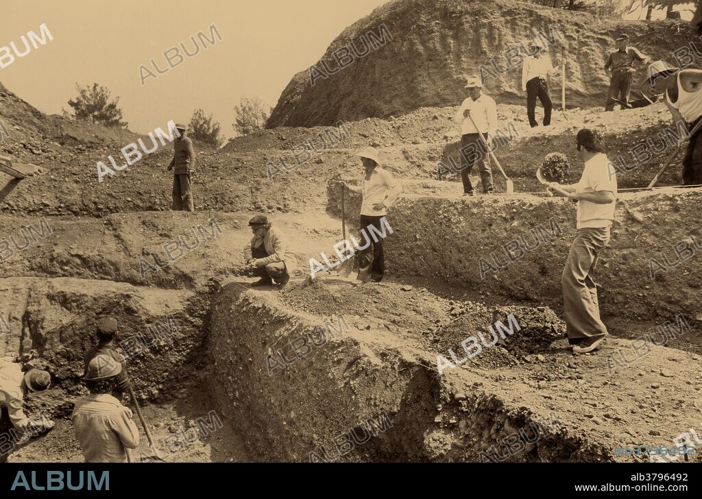 Professor Manolis Andronikos supervises excavations at the hill of Great Tumulus, Vergina, Greece. Andronikos discovered the tomb of Philip II of Macedon in 1977, and excavated Great Tumulus looking for the tombs of more Macedonian kings. Seven buried chambers were found in all.