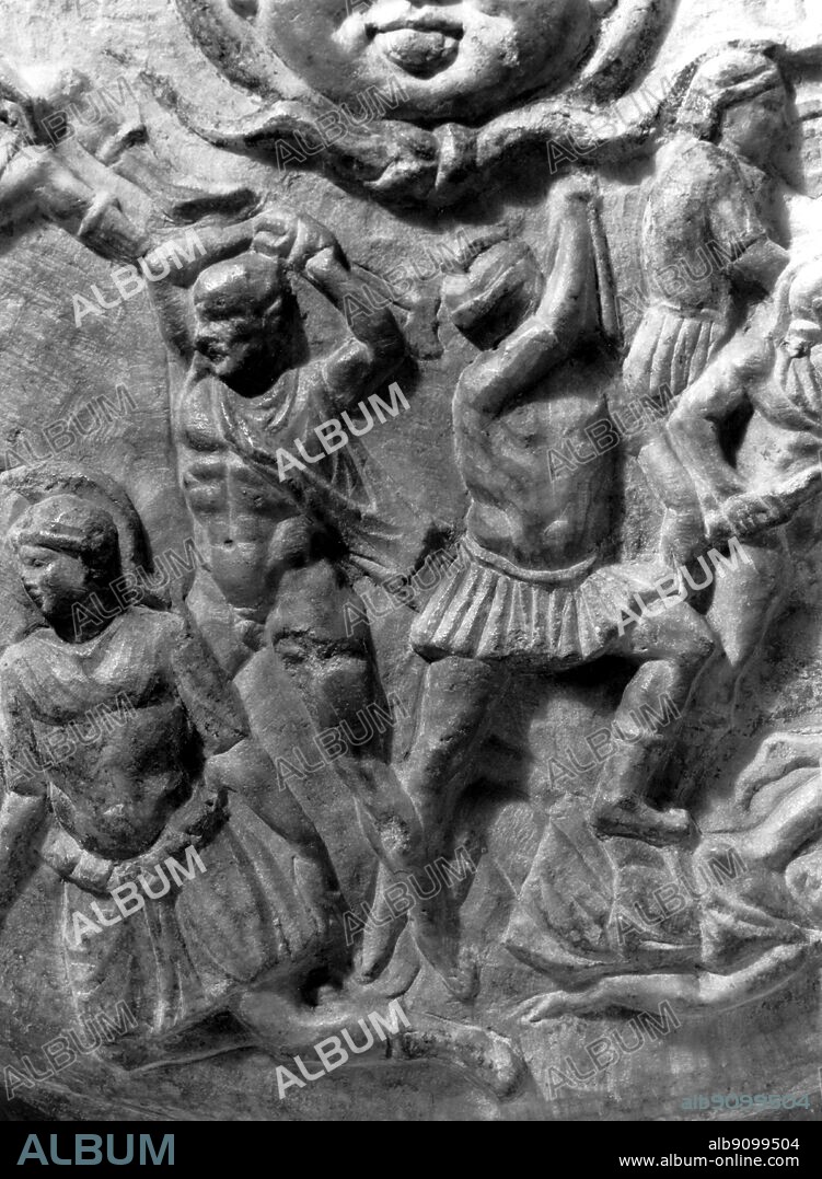 Roman copy of the shield of Phidias' Athena Parthenos. The bald Greek on the left about to strike a fallen Amazon is said to be Phidias himself and the helmetted man beside him whose arm hides his face, Pericles.