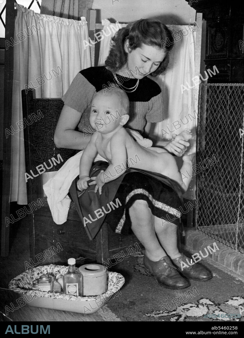Family make - up -- Nine-months-old "extra" Jeremy Hanley gets his first lessons in the use of make-up from his actress mother Dinah Sheridan. September 15, 1946.