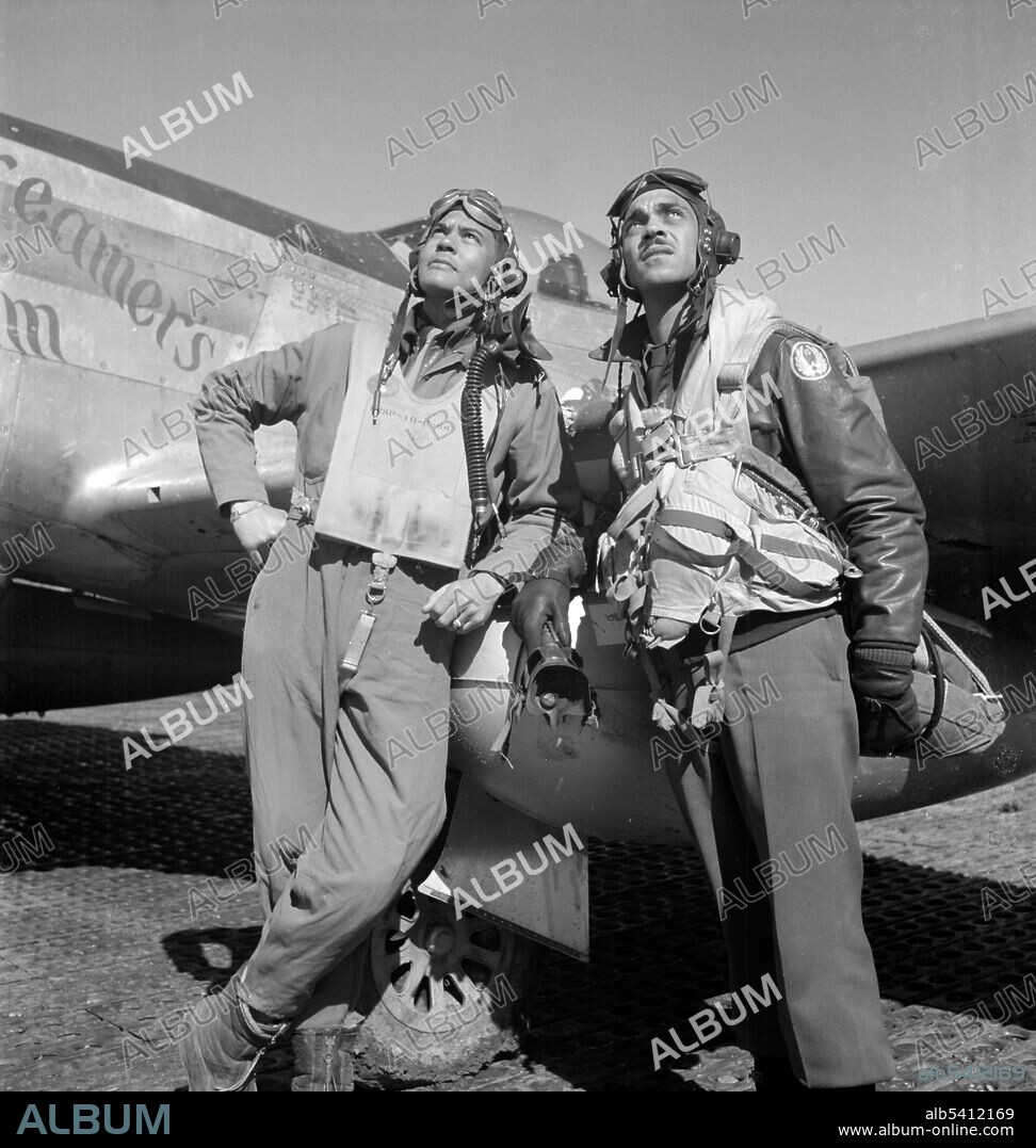 Col. Benjamin O. Davis and Edward C. Gleed, wearing flight gear, standing next to airplane, at air base at Ramitelli, Italy. Benjamin Oliver Davis Jr. (December 18, 1912 - July 4, 2002) was an American U.S. Air Force general and commander of the WWII Tuskegee Airmen. He was the first African-American general officer in the USAF. During WWII, Davis was commander of the 99th Fighter Squadron and the 332nd Fighter Group, which escorted bombers on air combat missions over Europe. Davis flew sixty missions in P-39, Curtiss P-40, P-47 and P-51 Mustang fighters. In 1948, President Truman signed Executive Order 9981 ordering the racial integration of the armed forces. Colonel Davis helped draft the Air Force plan for implementing this order. Davis served at the Pentagon and in overseas posts over the next two decades. He again saw combat in 1953 when he assumed command of the 51st Fighter-Interceptor Wing (51 FIW) and flew an F-86 Sabre in Korea. Davis followed in his father's footsteps in breaking racial barriers, as Benjamin O. Davis Sr. was the first African-American general in the U.S. Army. On December 9, 1998, he was advanced to four-star general by President Bill Clinton. Davis died in 2002 at the age of 89, and was interred at Arlington National Cemetery. A Red Tail P-51 Mustang, similar to the one he had flown in WWII, flew overhead during his funeral service. Photograph by Toni Frissell, 1945.