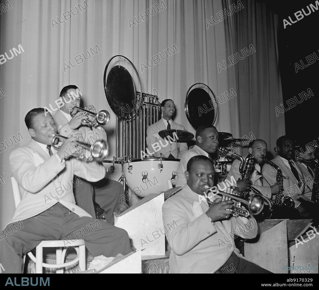 WILLIAM PAUL GOTTLIEB. Portrait of Barney Bigard, Ben Webster, Otto Toby Hardwick(e), Harry Carney, Rex William Stewart, Sonny Greer, Wallace (Leon) Jones(?), and Ray Nance, Howard Theater(?), Washington, D.C., between 1938 and 1948.