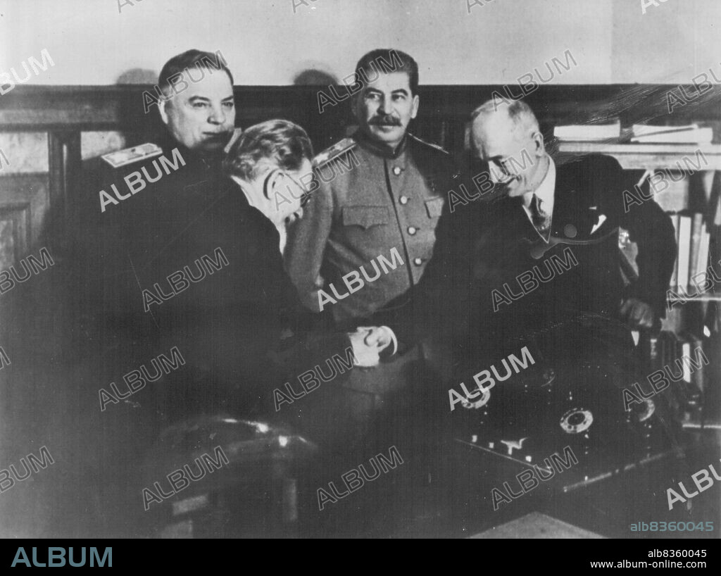 Moscow The Kremlin -- After the signing of the treaty of friendship mutual assistance and postwar collaboration between the USSR and the Czechoslovak republic M. Kalinin and E. Benes are shaking hands. standing are J. Stalin and K. Voroshilow. March 01, 1944.