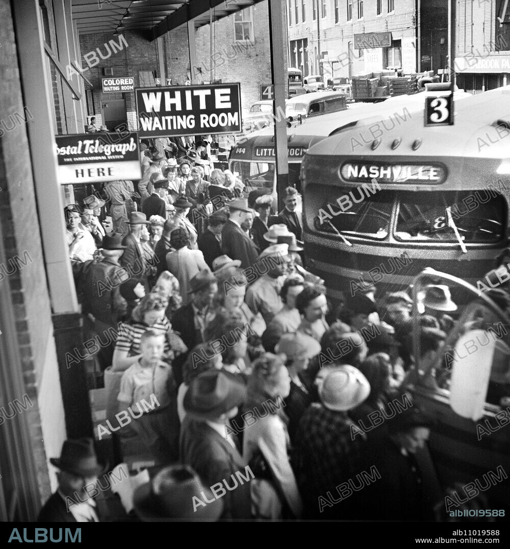 Crowded bus terminal with ""White Waiting Room"" sign in foreground and ""Colored Waiting Room"" in background, Memphis, Tennessee, USA, Esther Bubley, U.S. Office of War Information, September 1943.