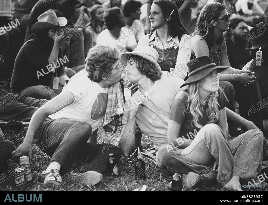 Editorial use only . Two friends share a lungful of marijuana via a smoking method known as a shotgun. The man on the right is blowing smoke into the mouth of the man on the left. This was taken at the Grandfather Mountain Music Festival held in Linville, North Carolina in 1977.