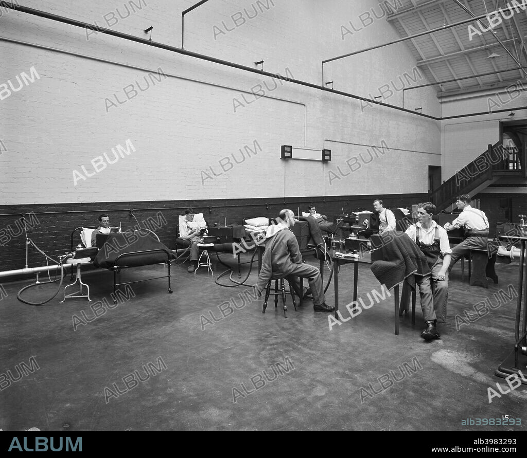Pilkington Special Hospital, Borough Road, St Helens, Lancashire, September 1918. Wounded servicemen receiving thermo-therapy (hot dry-air treatment) at the Pilkington Special Hospital. Their limbs are being subjected to hot dry air (250 Fahrenheit to 300 Fahrenheit) in asbestos lined cabinets. The Pilkington Special Orthopaedic Hospital was conceived by surgeon James R Kerr along with Pilkington Brothers, glass manufacturers. It was established in 1916 for the treatment and rehabilitation of servicemen disabled during the First World War.