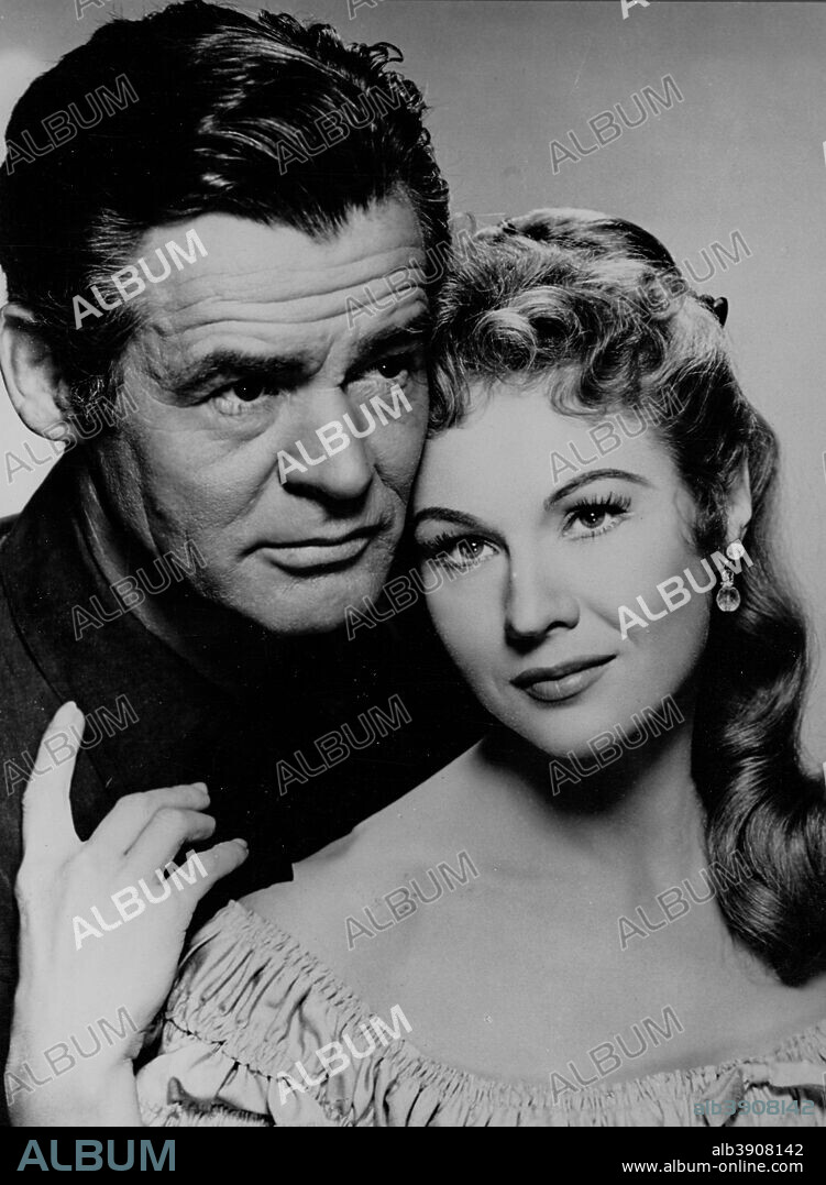 ROBERT RYAN and VIRGINIA MAYO in THE PROUD ONES, 1956, directed by ROBERT D. WEBB. Copyright 20TH CENTURY FOX.