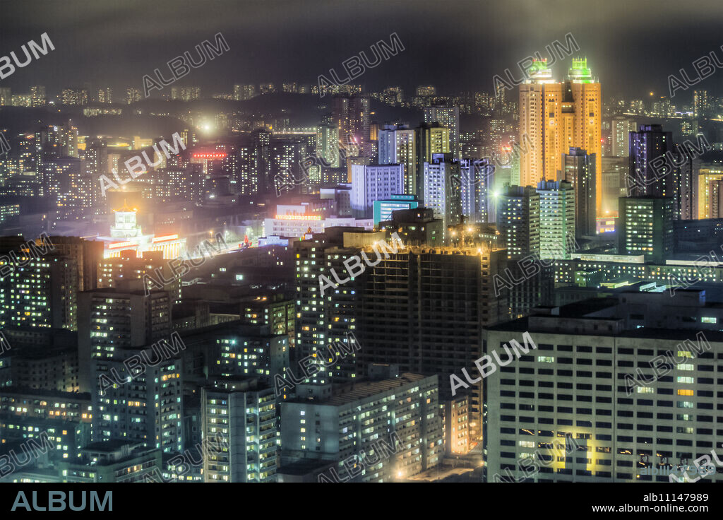 New modern buildings in the centre of Pyongyang colourfully illuminated at night, Pyongyang, Democratic People's Republic of Korea (DPRK), North Korea, Asia.