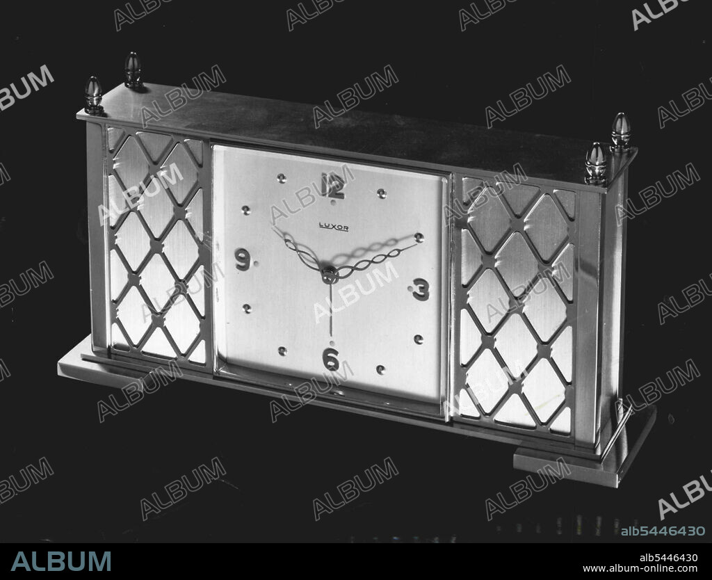 This is an musical alarm clock.. a Luxor from Switzerland. 15 jewels... eight day clock in a gilt case. £27.0.0. June 27, 1955. (Photo by Visatone (Aust.) Pty. Ltd.).