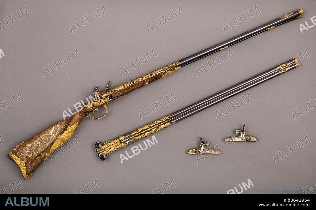 Double-Barreled Flintlock Shotgun with Exchangeable Percussion Locks and Barrels. Barrelsmith: Exchangeable percussion barrels by Léopold Bernard (French, Paris, active 1832-70). Culture: French, Versailles and Paris. Dimensions: L. of gun 47 3/8 in. (120.3 cm); L. of double barrel 31 7/8 in. (81.0 cm); L. of percussion locks 5 in. (12.7 cm); L. of bullet pouch 7 1/4 in. (18.4 cm); L. of priming flask 6 5/8 in. (16.8 cm); L. of bullet mold 6 3/4 in. (17.1 cm); L. of ramrod extension 10 3/8 in. (26.4 cm); L. of hammer extractor 2 3/16 in. (5.6 cm); L. of brush for cleaning barrel 2 13/16 in. (7.1 cm); L. of bullet extractor 1 5/16 in. (3.3 cm); L. of screwdriver 6 in. (15.2 cm); L. of bullet extractor 3 1/8 in. (7.9 cm); L. of touch hole cleaner 3 3/16 in. (8.1 cm); Cal. .61 in. (15.5 mm); Wt. of gun 6 lbs. 15 oz. (3150 g); Wt. of double barrel 3 lbs. 8 oz. (1600 g); Wt. of percussion locks 5 oz. (150 g); Wt. of bullet pouch 2.5 oz. (71 g); Wt. of priming flask 4.6 oz. (131 g); Wt. of bullet mold 7 oz. (198 g). Gunsmith: Nicolas Noël Boutet (French, Versailles and Paris, 1761-1833). Lock maker: Exchangeable percussion locks by B. Montagnon (French, active ca. 1850). Retailer: Exchangeable percussion locks and barrels originally sold by G. Zaoué (French, active 1857-61). Date: ca. 1818-20; exchangeable percussion locks and barrels, dated 1860.
Perhaps the richest and most beautiful gun from the last phase of Boutet's long career, this firearm was made by him after the Restoration of the monarchy in France in 1815. Its exuberant decoration is reminiscent of the style fashionable before the revolution in 1789. The gun was so appreciated by its owner that, in 1860, he commissioned a group of skillful gunmakers to produce a similarly decorated set of barrels and locks using percussion caps, an advanced method of ignition developed after 1820.