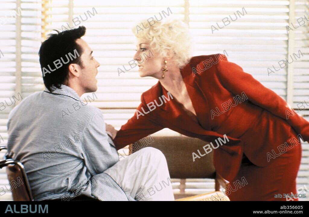 ANJELICA HUSTON and JOHN CUSACK in THE GRIFTERS, 1990, directed by STEPHEN FREARS. Copyright CINEPLEX ODEON FILMS, INC.