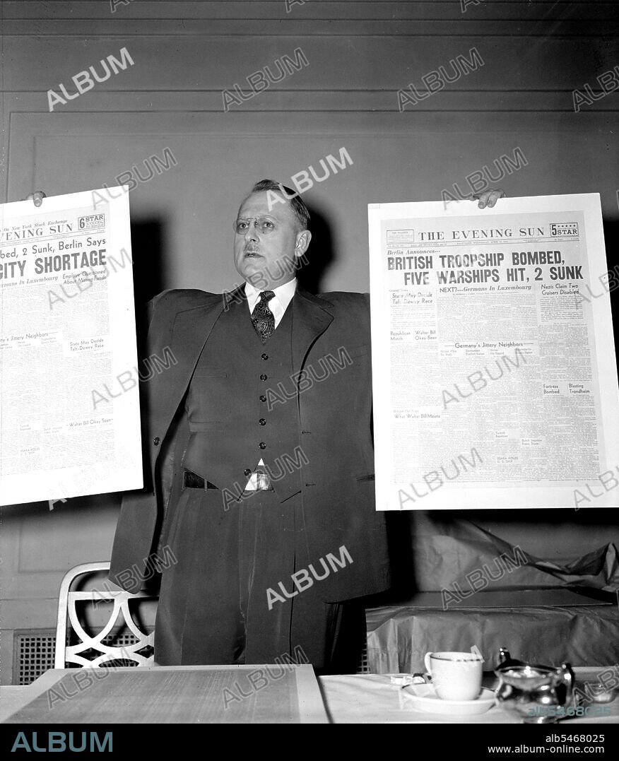 Man holding up The Evening Sun newspaper headlines about Germans sinking British ships circa 1940 .