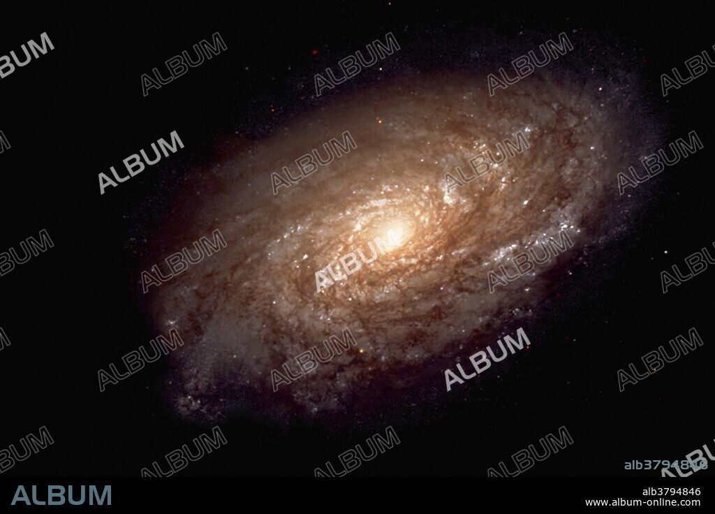 Magnificent details in a dusty spiral galaxy. The spiral galaxy NGC 4414 imaged by the Hubble Space Telescope (HST) as part of the HST Key Project on the Extragalactic Distance Scale. Images were obtained with Hubble's Wide Field Planetary Camera 2 (WFPC2). The distance to NGC 4414, 19.1 megaparsecs or about 60 million light-years, contributes to astronomers' knowledge of the rate of expansion of the universe. The Hubble picture shows that the central regions of this galaxy contain primarily older, yellow and red stars. The outer spiral arms are considerably bluer due to ongoing formation of young, blue stars.