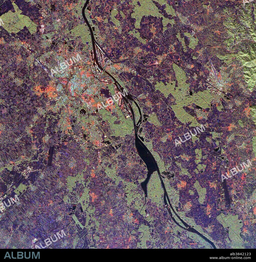 Spaceborne radar image shows a segment of the Rhine River where it forms the border between the Alsace region of northeastern France on the left and the Black Forest region of Germany on the right. The river valley is densely populated, as seen in this image, which shows the French city of Strasbourg, the light blue and orange area in the upper left center; and the German cities of Kehl, across the river from Strasbourg and Offenburg, the bright area in right center. The fertile valley is famous for its wine production and most of the agricultural areas in the image, shown in purple patches, are vineyards. The light green areas are forest. Scientists can use radar images like this one to monitor the effects of urban and agricultural development on sensitive ecosystems such as the Rhine River valley. Image was acquired by the SIR-C/X-SAR onboard the Endeavour on October 2, 1994. The colors are assigned to different radar frequencies and polarizations of the radar as follows: red is L-band, horizontally transmitted and received; green is L-band, horizontally transmitted, vertically received; and blue is C-band, horizontally transmitted, vertically received.