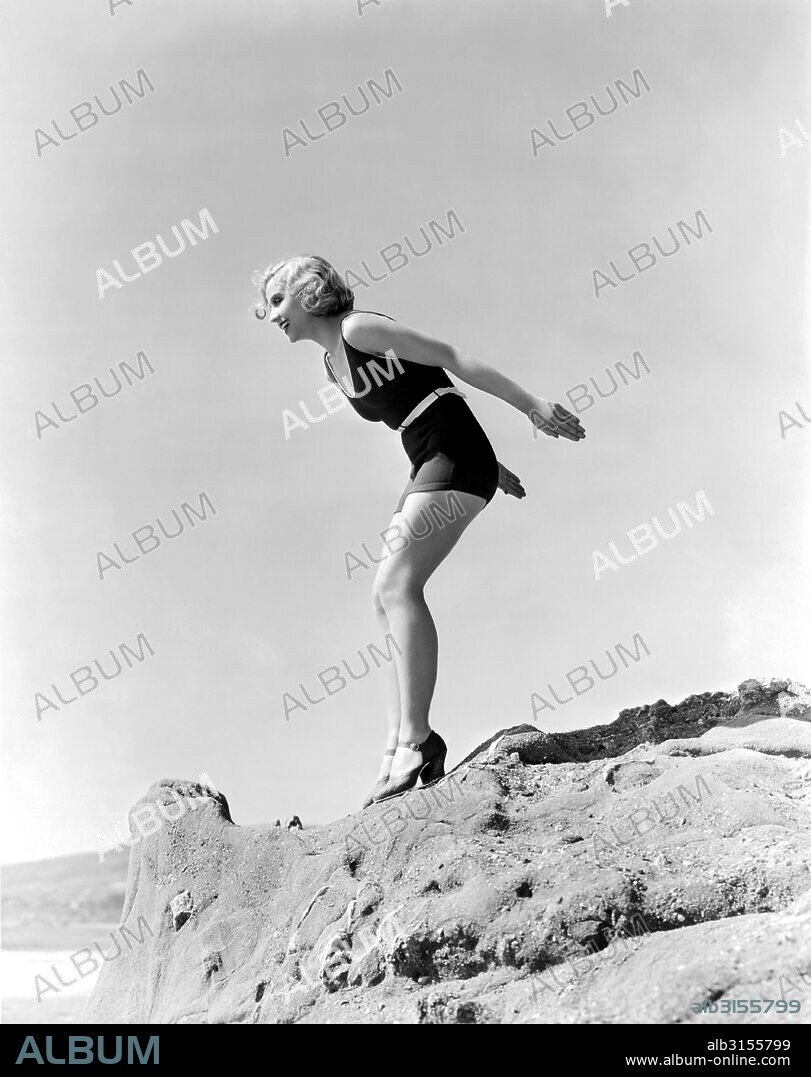 Hollywood, California:  c. 1929. Adrienne Dore, actress and the 1925 Miss America, contemplates a dive off the rocks into the ocean.