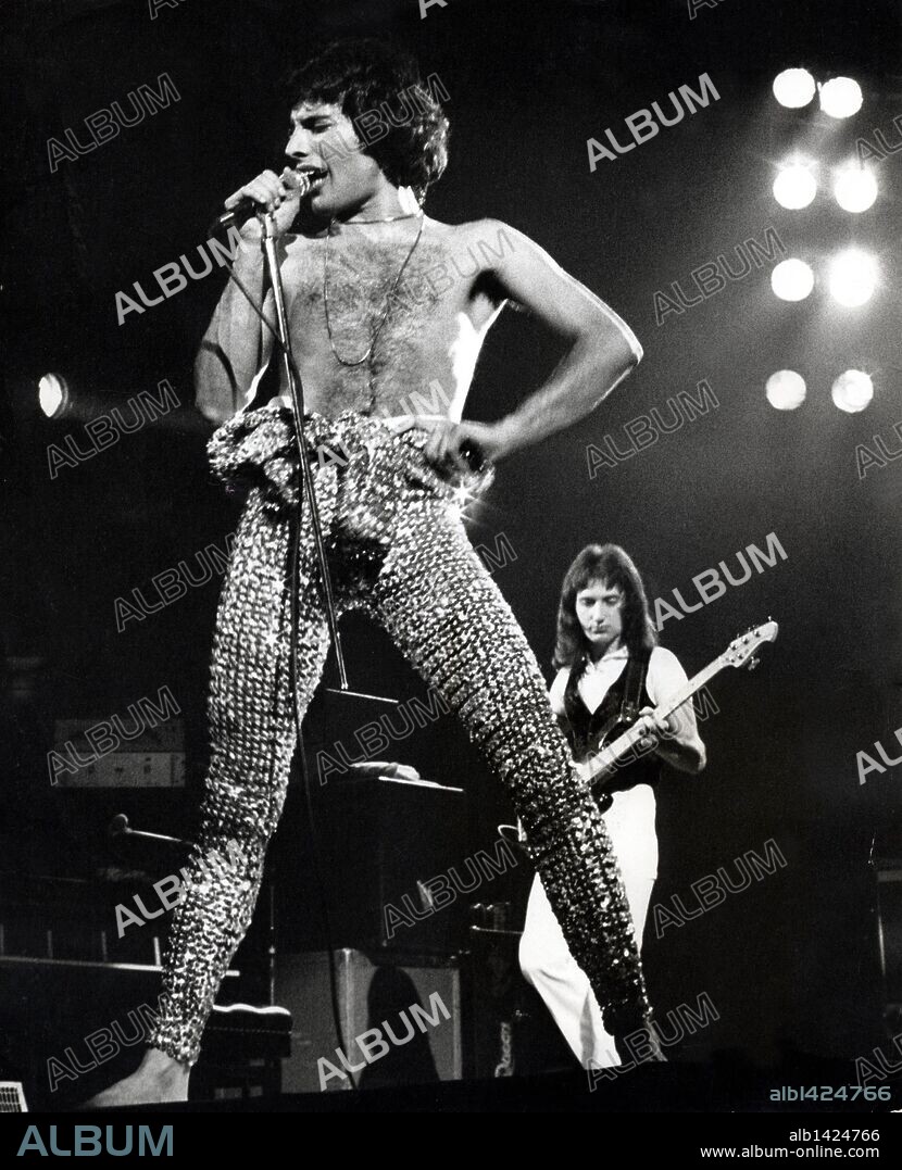 Jun 11, 1977 - London, England, UK - Born FAROOKH BULSARA, the lead singer for rock group Queen, FREDDIE MERCURY has been referred to as 'Britain's first Asian rock star.' Melding glam-rock with hard-rock, the group's ornate, multi-tracked recordings and in-your-face songs resulted to worldwide sales of more than 130 million records. Regarded by fans and critics alike as a consummate showman, Mercury was openly bisexual and enjoyed a colourful rock-star lifestyle. PICTURED: MERCURY during a concert in Earl's Court; JOHN DEACON in the background. (Credit Image: © Keystone Pictures/ZUMA Press) RESTRICTIONS: * Germany Rights OUT * (FILE PHOTO: Exact Date And Location Unknown). 11/06/1977